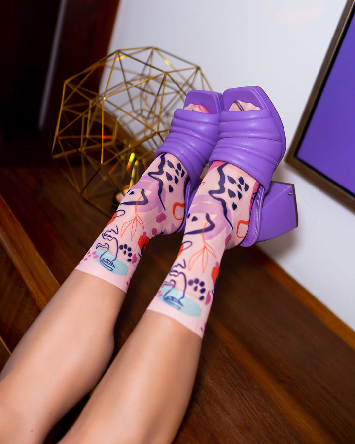 a model wearing the abstract socks with purple platform shoes