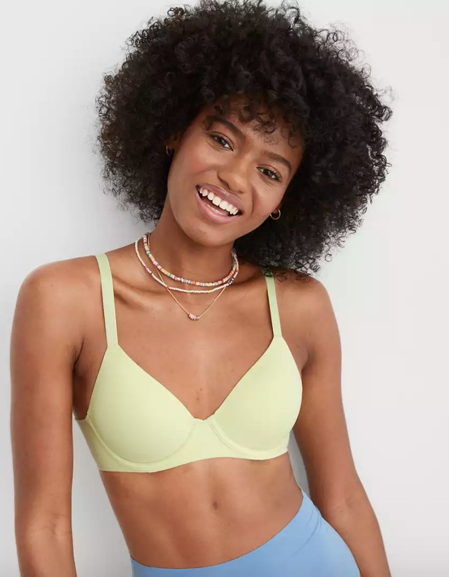 Model wearing yellow bra with blue pants