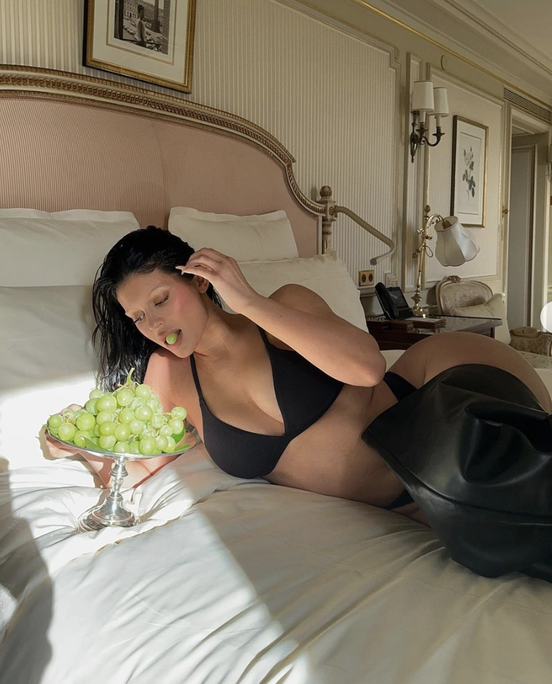 Kylie Jenner in bed eating grapes