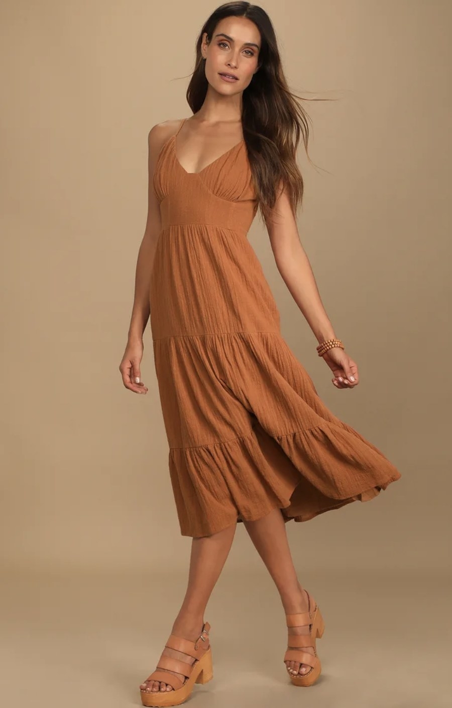 A rust brown tiered midi dress