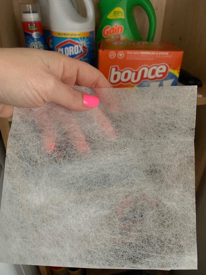 A reviewer holding a dryer sheet