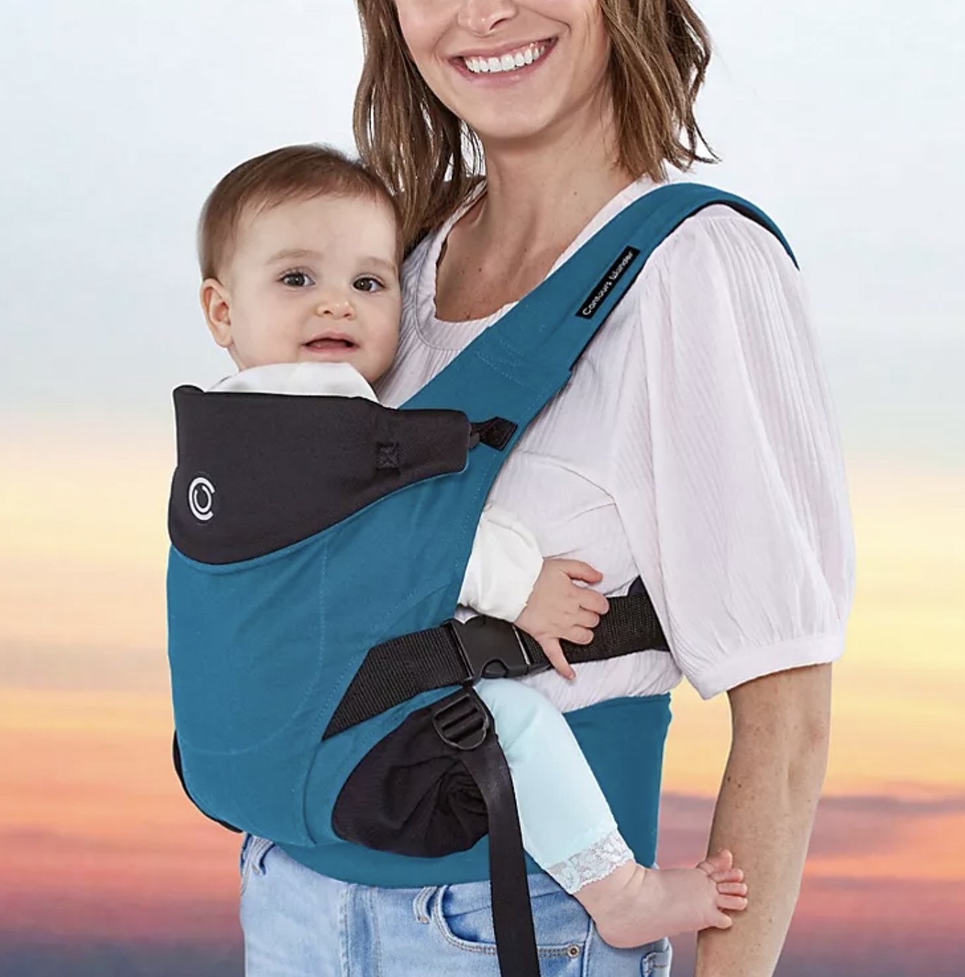 Model with toddler in the blue carrier facing forward