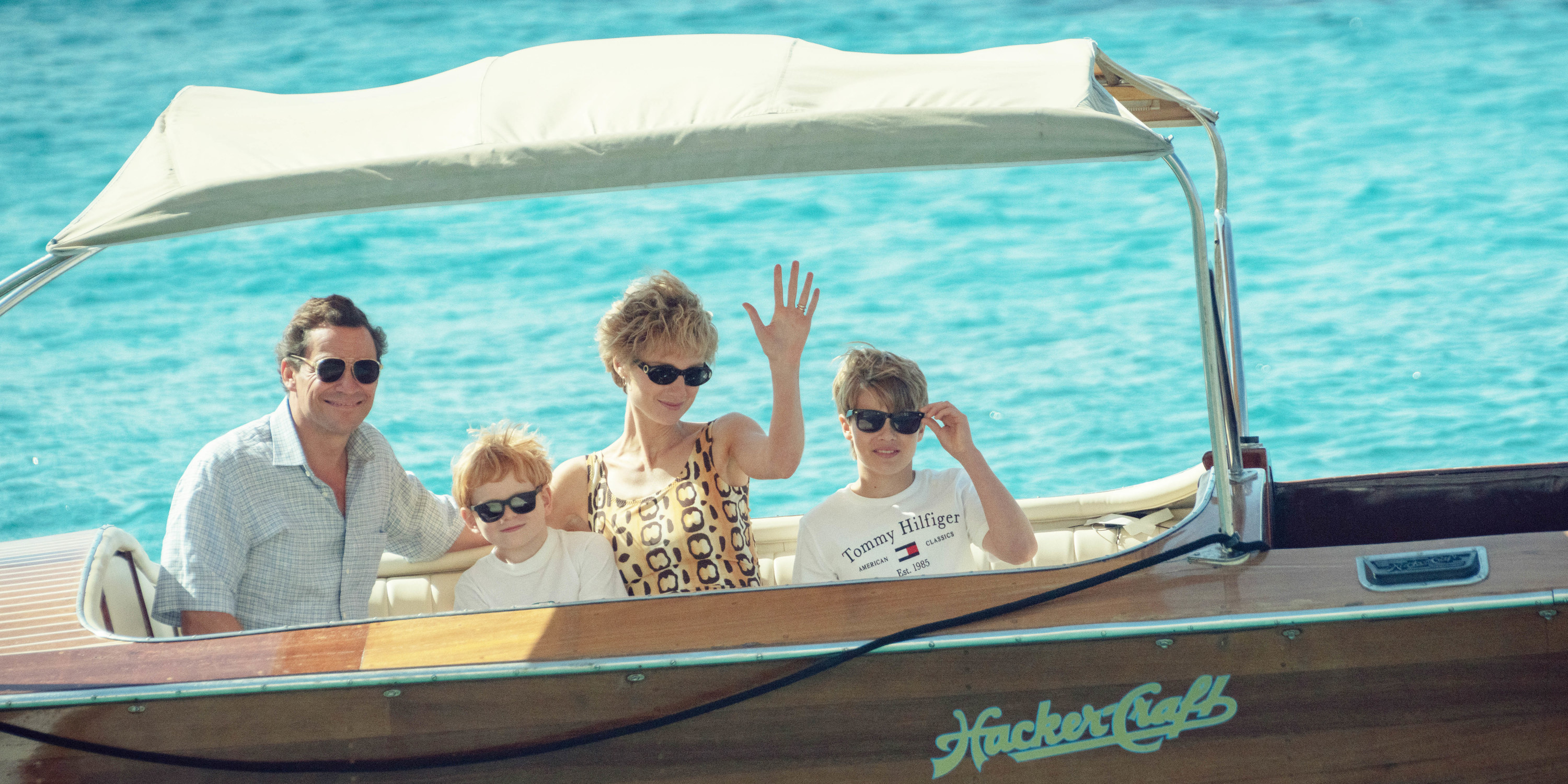 Charles, Diana, Harry, and William in a boat