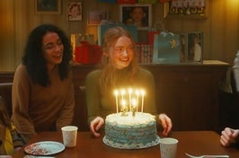 Sadie Sink smiling in front of a birthday cake in the All Too Well short film