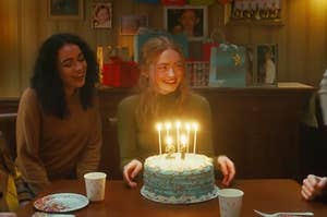 Sadie Sink smiling in front of a birthday cake in the All Too Well short film