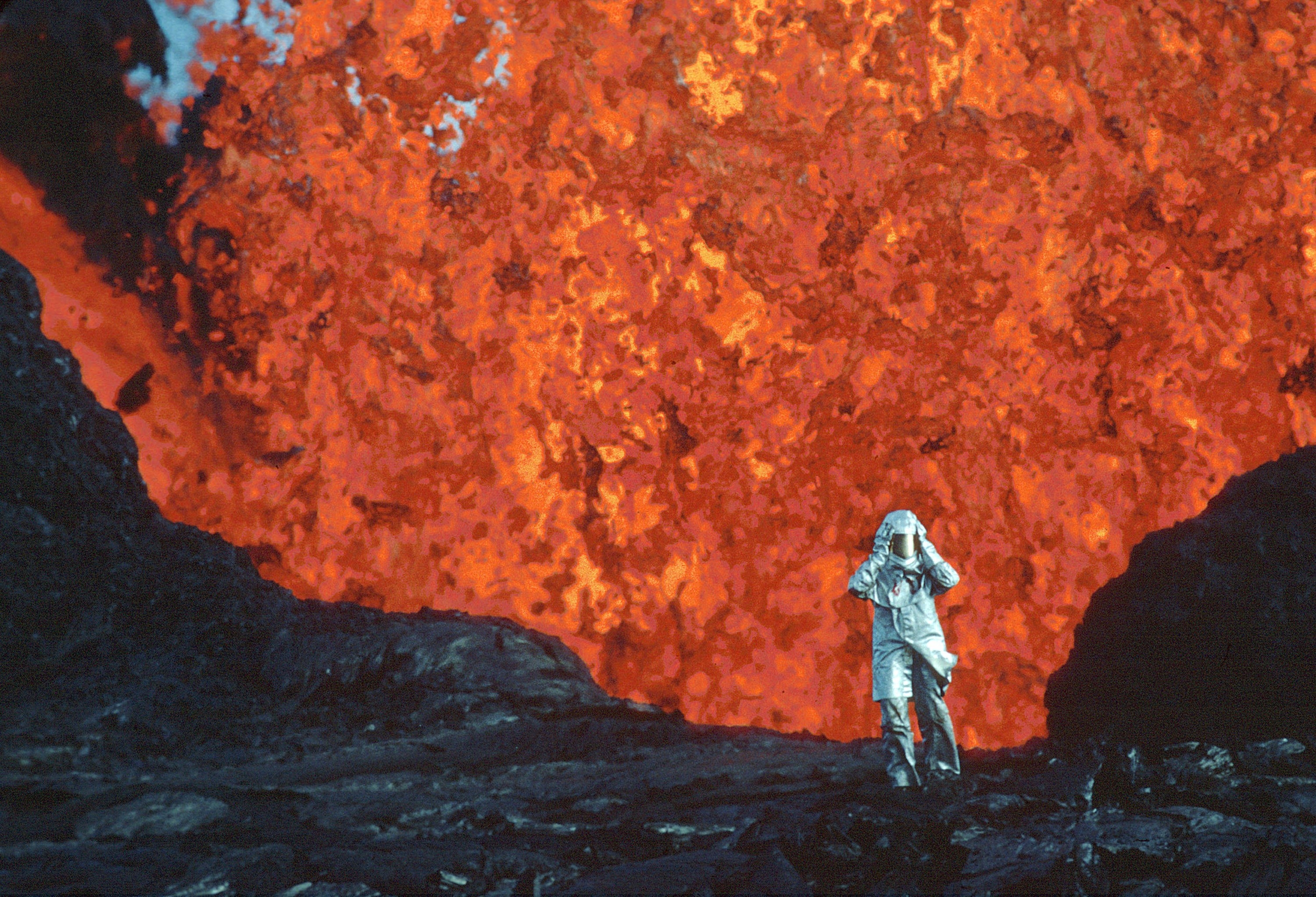Katia Krafft stands near a volcano