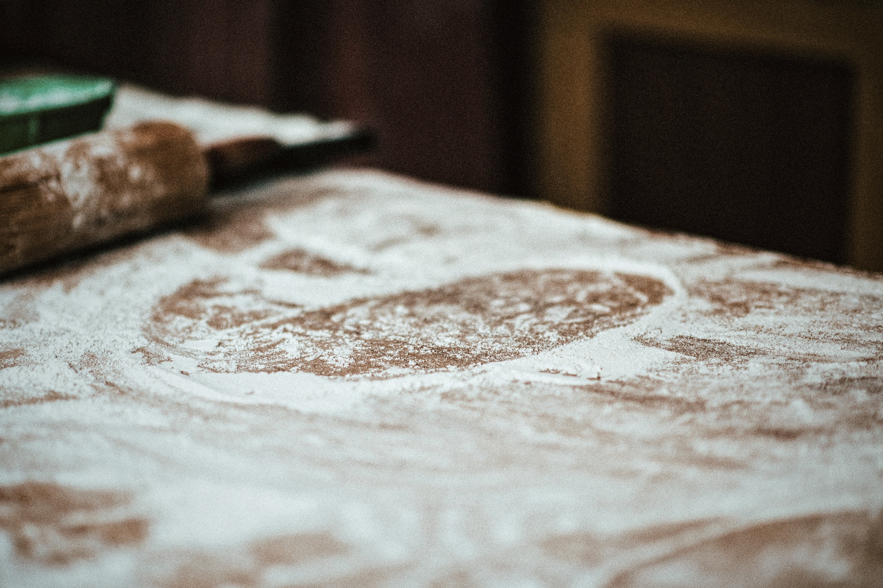 Close-up of flour covering a kitchen table