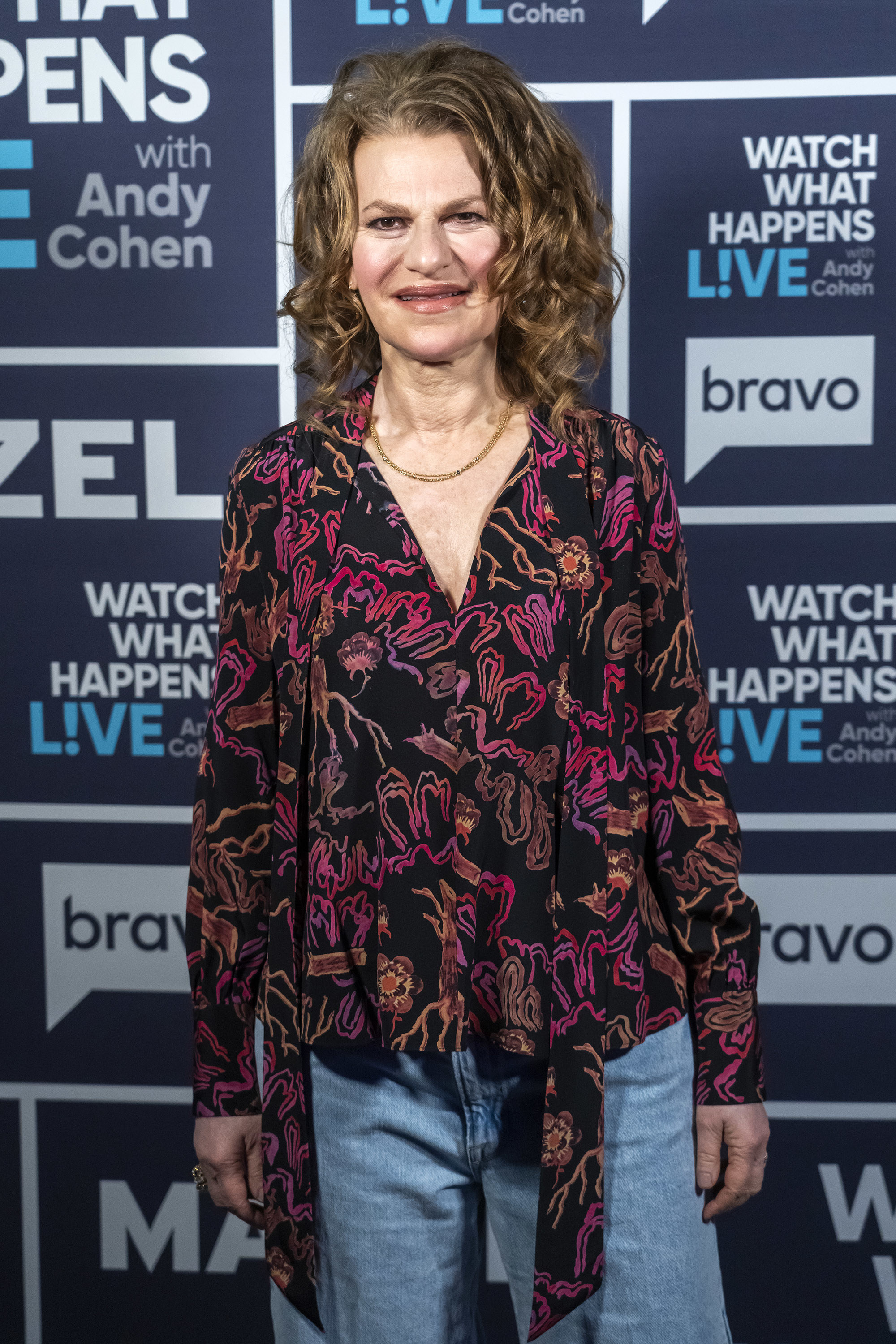 Sandra Bernhard on the red carpet in jeans and a colorful blouse