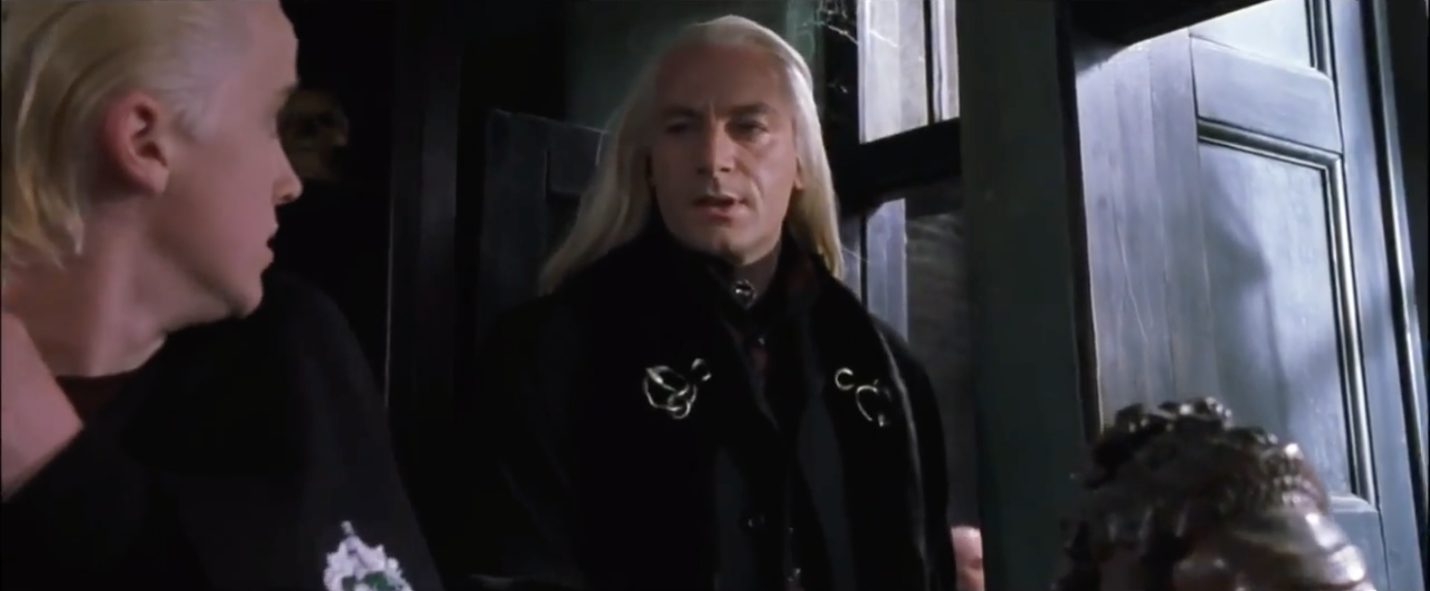 Lucius speaking to a nervous Malfoy