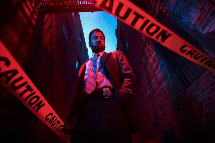 Kal Penn in AHS: NYC standing next to a police caution line with tape