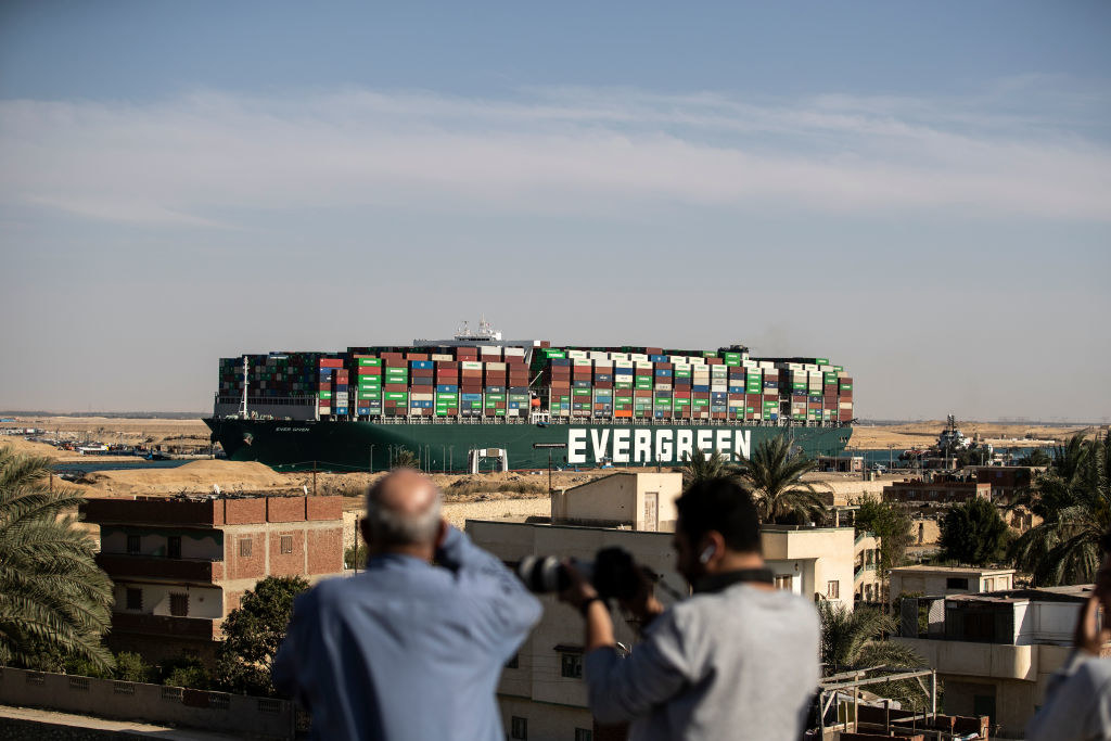 An &quot;Evergreen&quot; barge with multicolored containers on it in the water