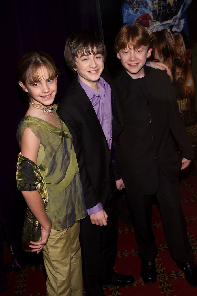 From left to right, Emma Watson, Daniel Radcliffe, and Rupert Grint posing for photographers