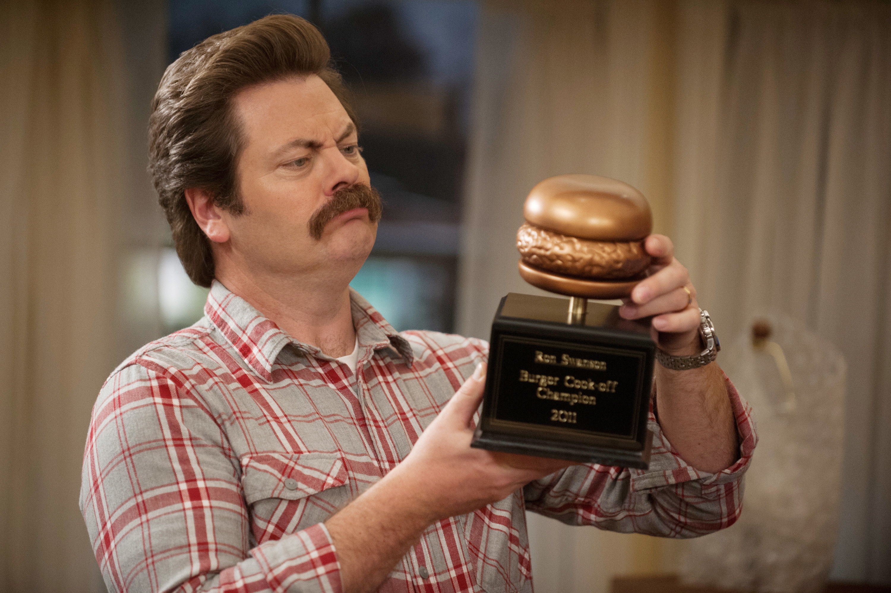 Ron holding a burger cook-off trophy