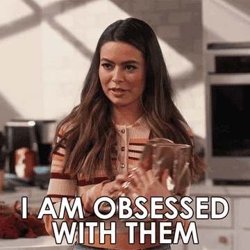 a gif of a person holding a pair of boots saying &quot;I am obsessed with them&quot;