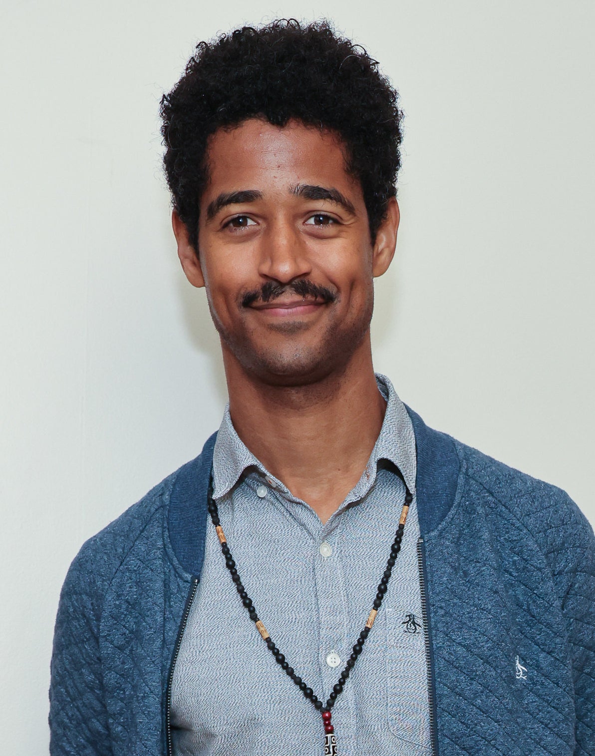 closeup of Alfred Enoch smiling