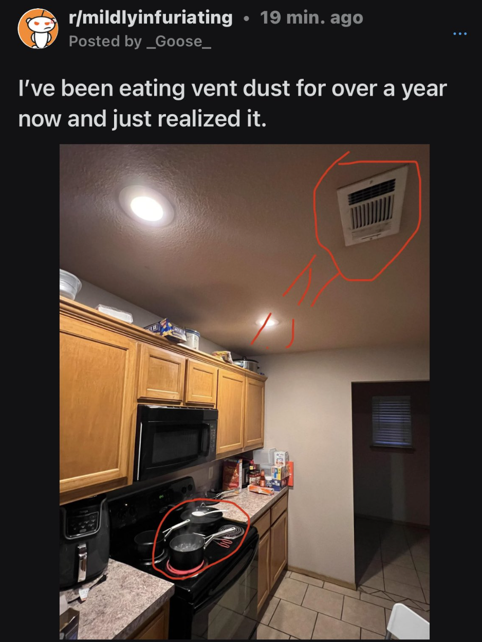 A kitchen with a ceiling vent and a stove top circled below it