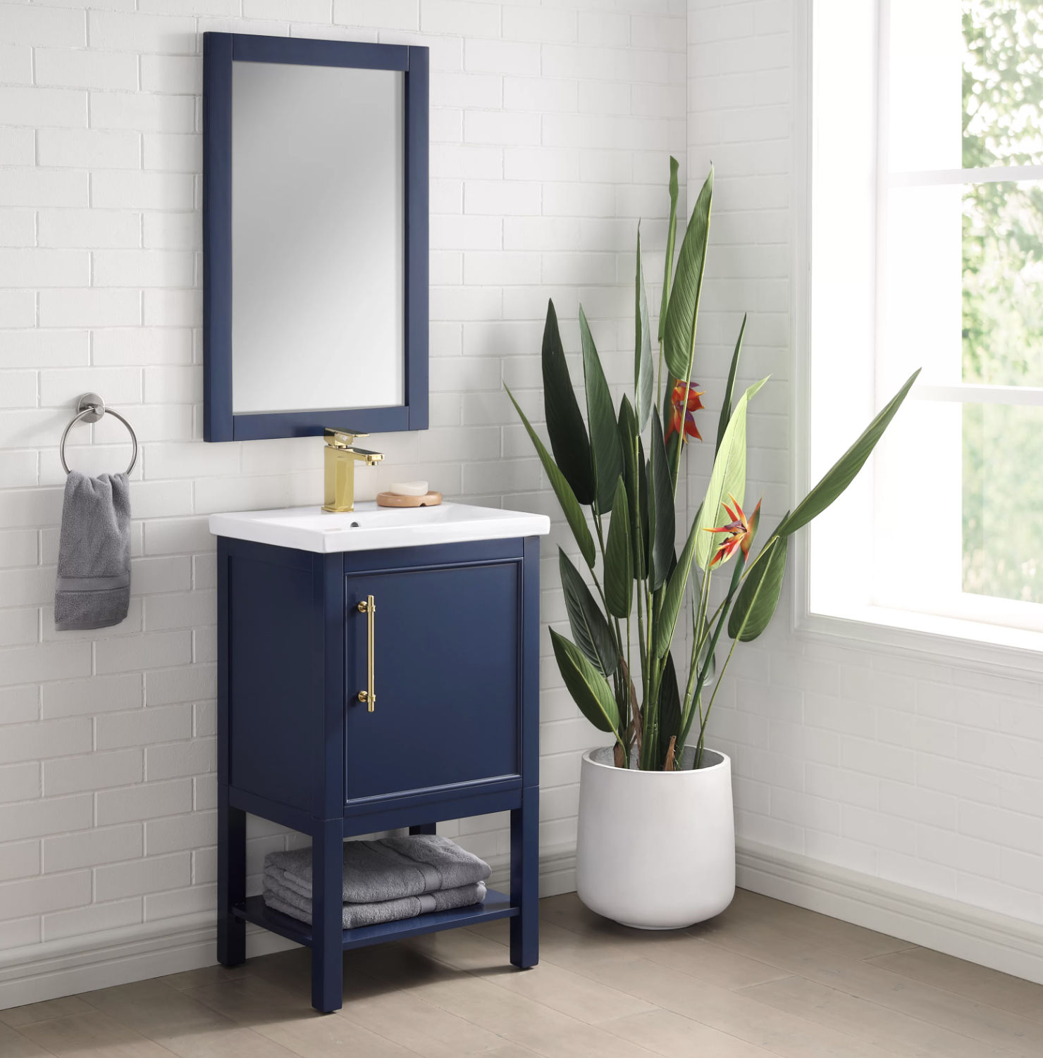 A navy blue bathroom vanity set with gold detailing