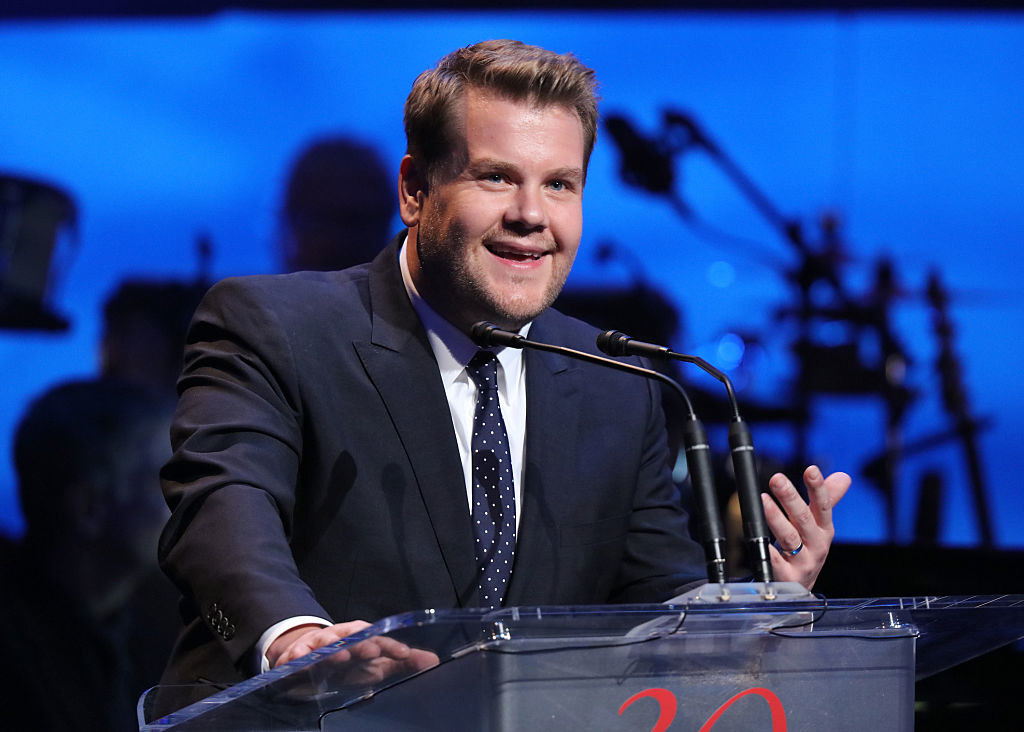 James speaking at a podium onstage