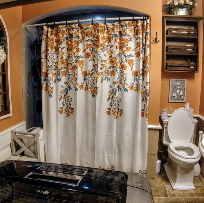reviewer image of the shower curtain with orange flowers on it