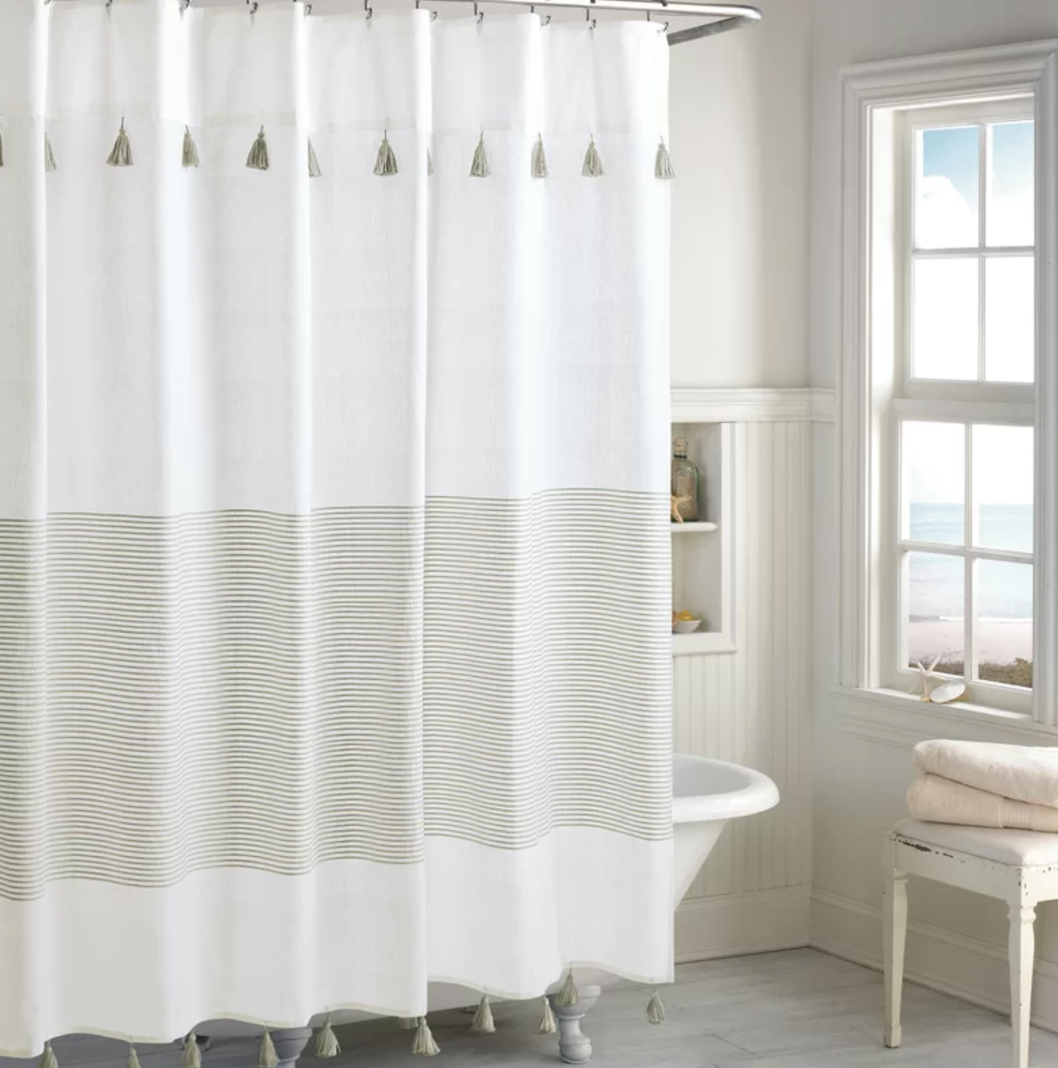 A striped cotton shower curtain with black tassels