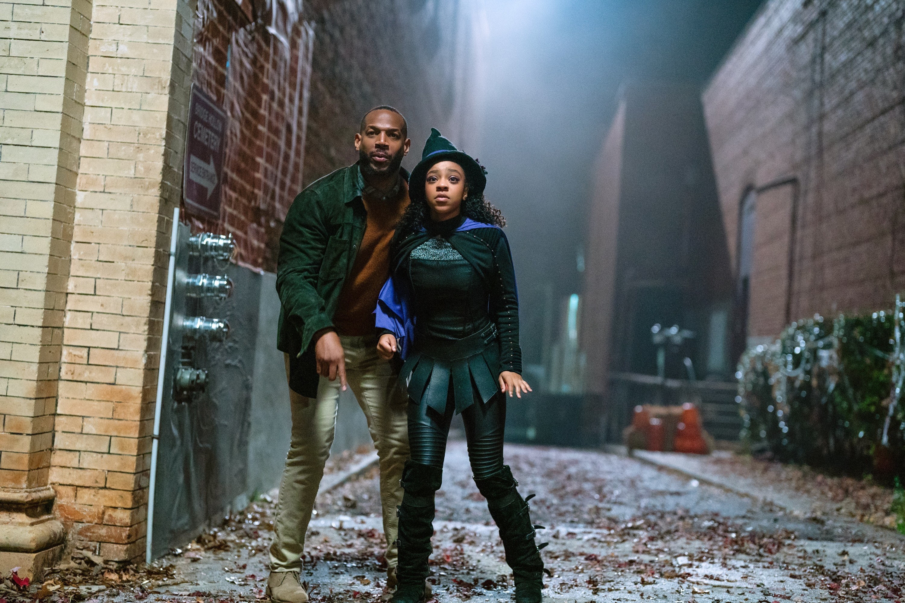 Marlon and Priah standing in a dark alleyway in a scene from the film