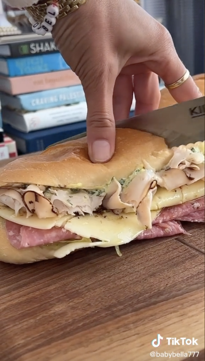 Bella slicing the sandwich in half