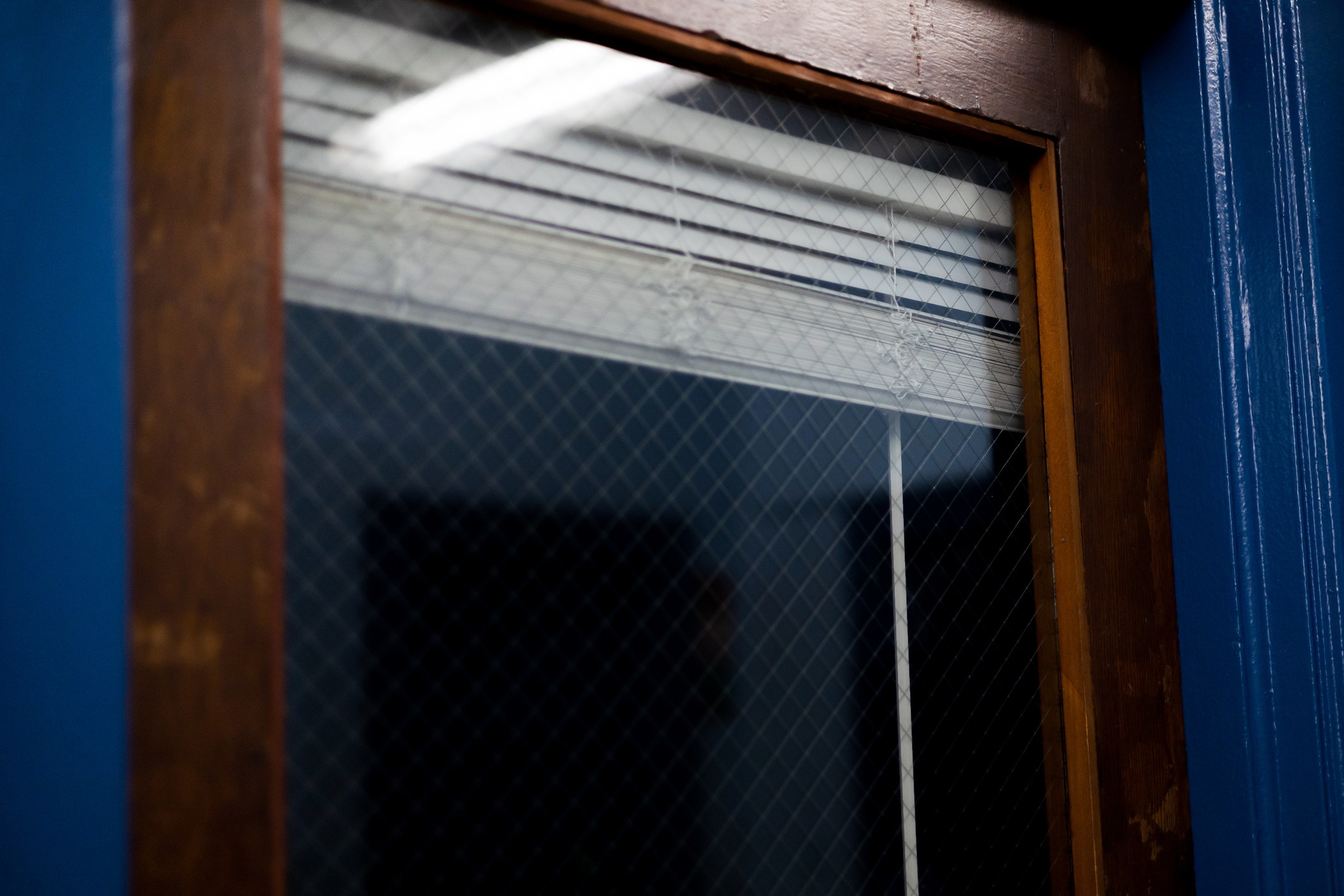 exterior of an indoor door with a window and blinds