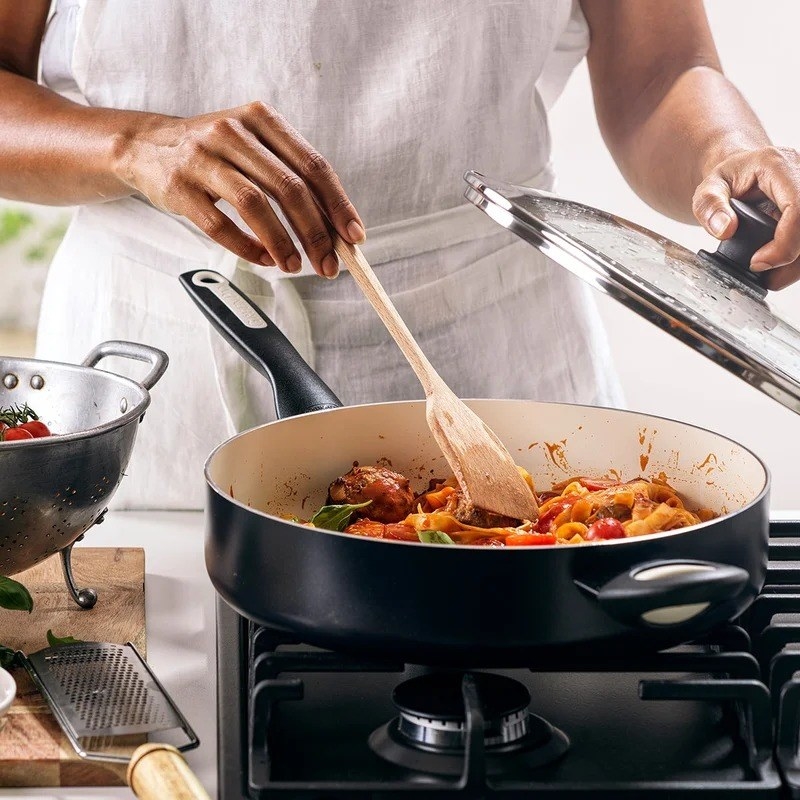 a photo of the ceramic pan being used to make pasta over a gas stovetop