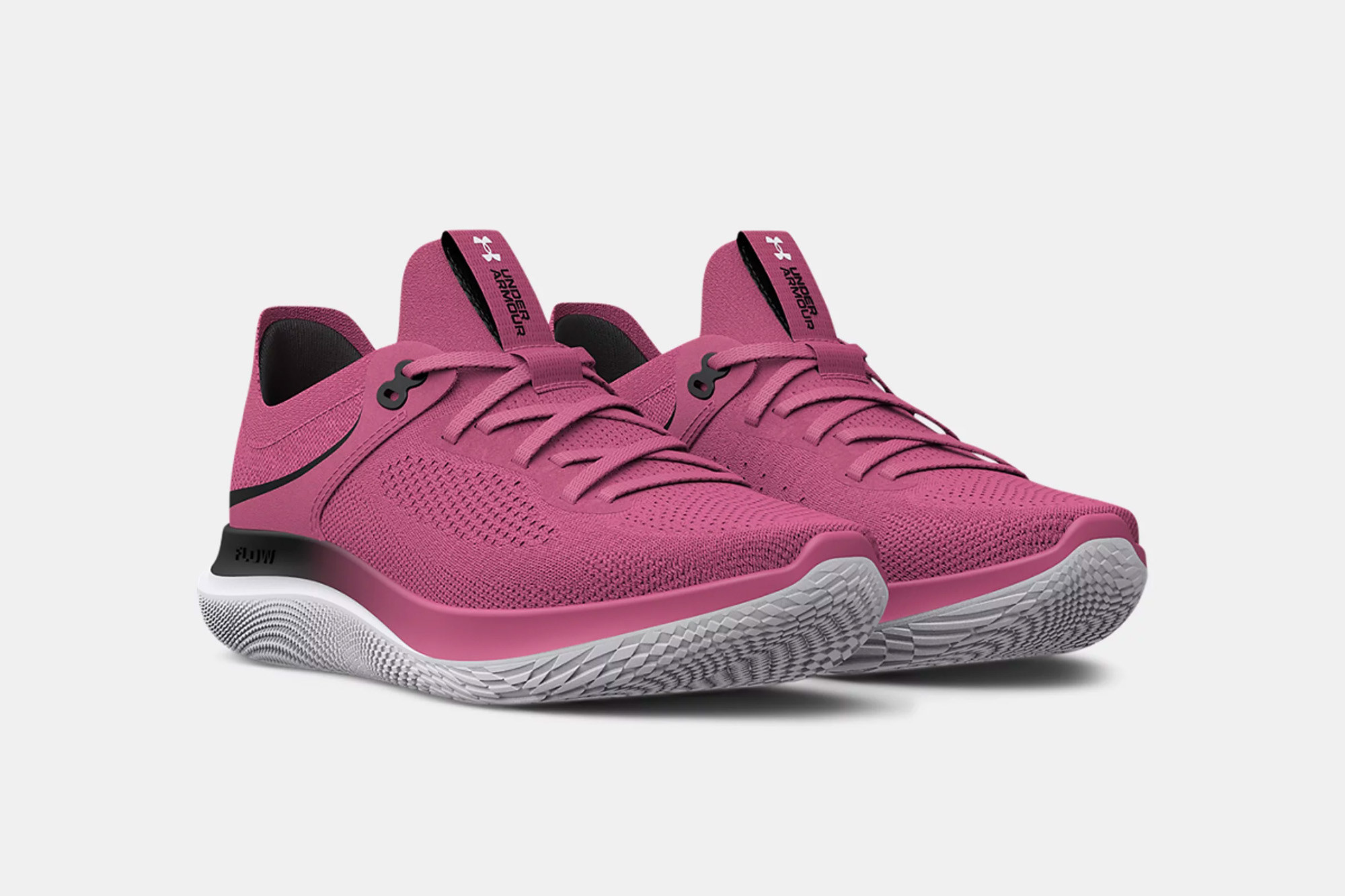 pink gym shoes with white soles that have a geometric design on it