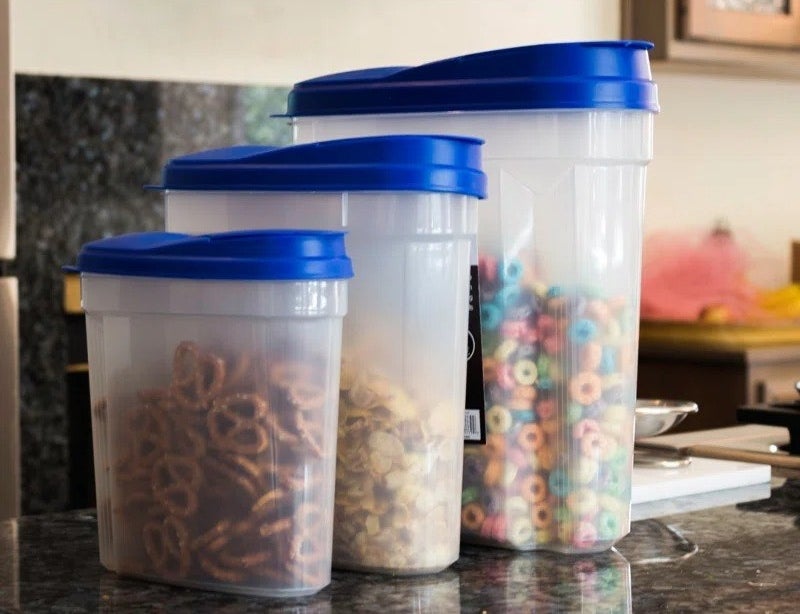 a professional photo of the set of three canisters with the two largest holding cereal and the smallest pretzels