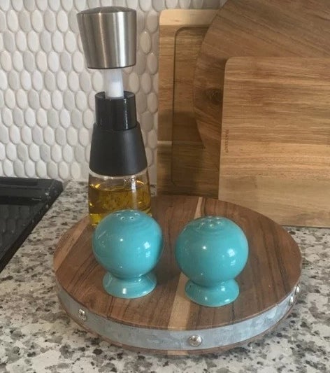 a reviewer photo of the salt and pepper shakers in the turquoise shade