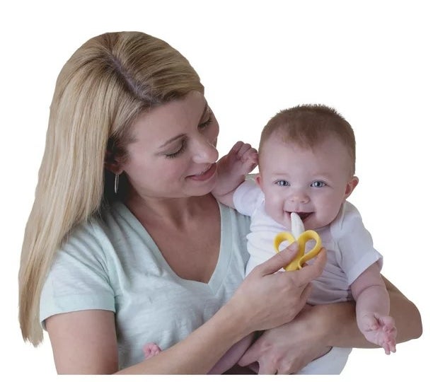 Women holding baby with teether