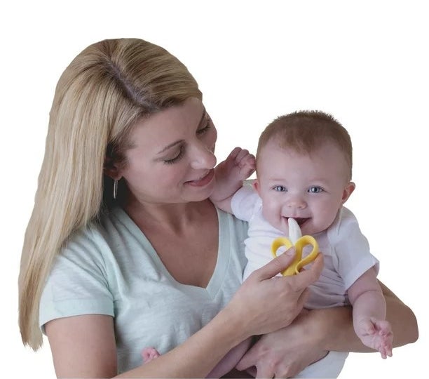 model holding baby with teether