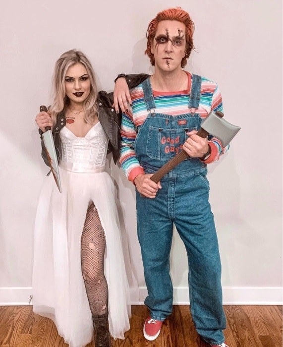 People dressed as Chucky the Doll and Tiffany Valentine, holding weapons