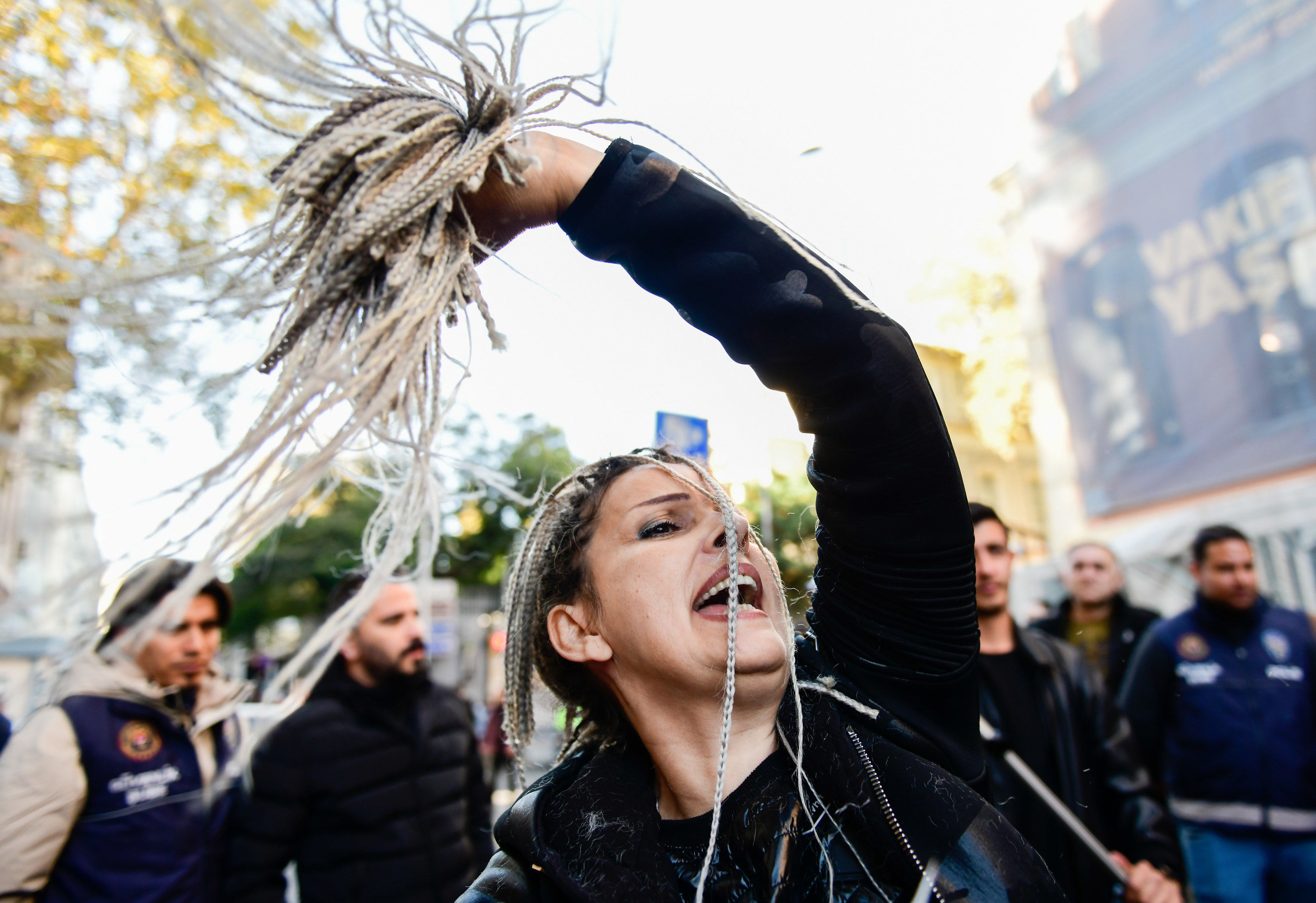 A protestor cuts her hair off as a show of protest against the Iranian government crackdown on conservative dress laws.
