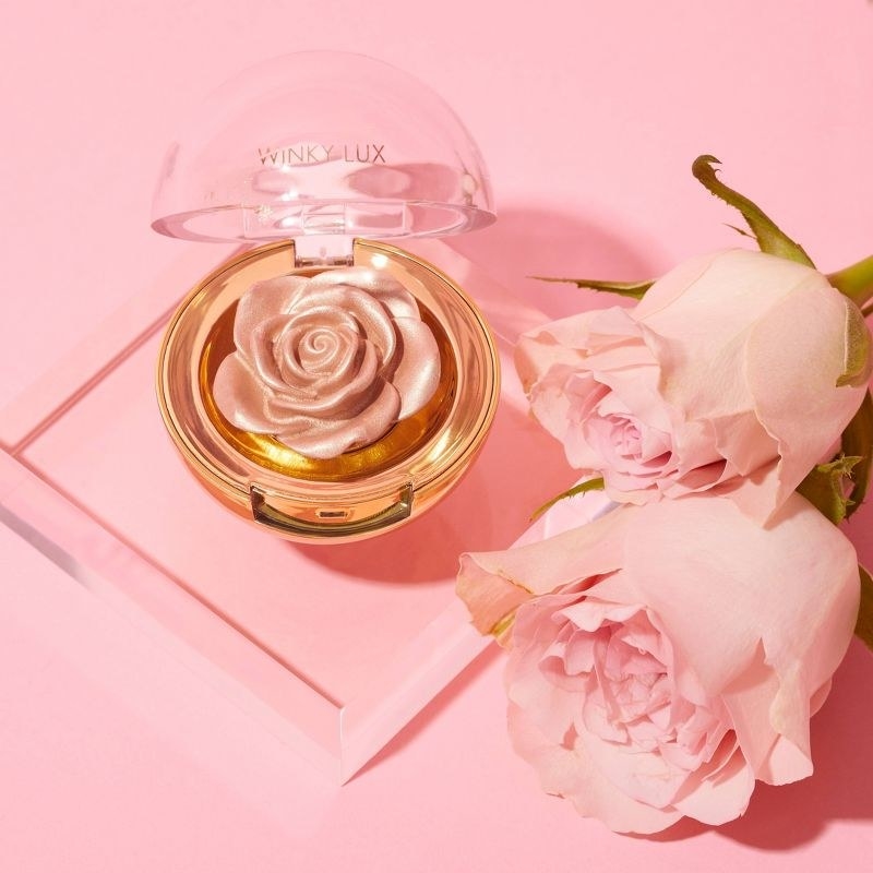 A rose-sculpted highlighter compact with two rose buds