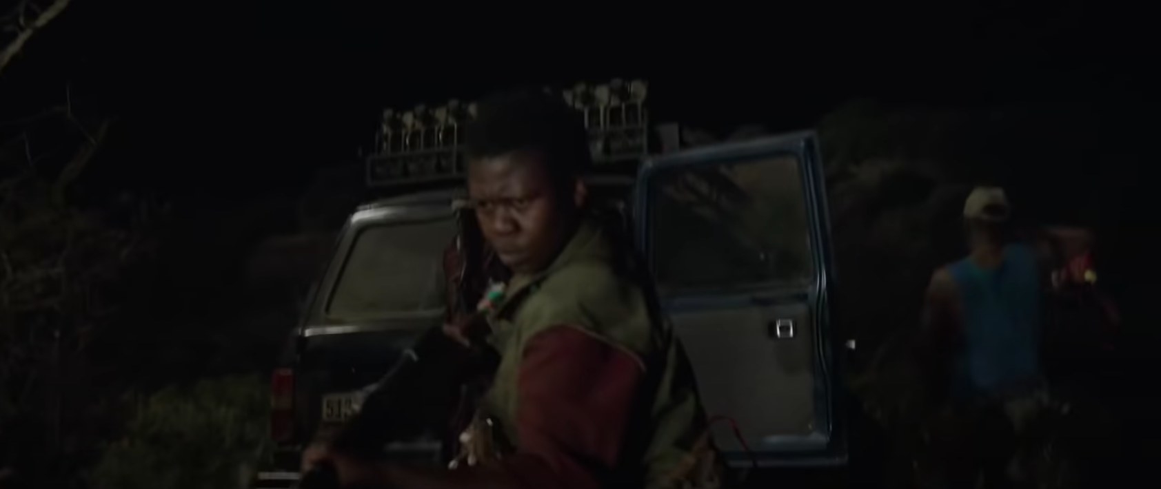 Poachers pointing guns in Beast film
