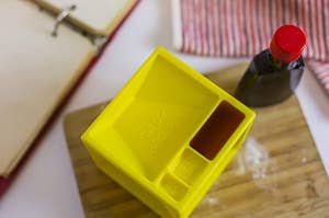 The yellow cube with vanilla extract measured into one of the divots