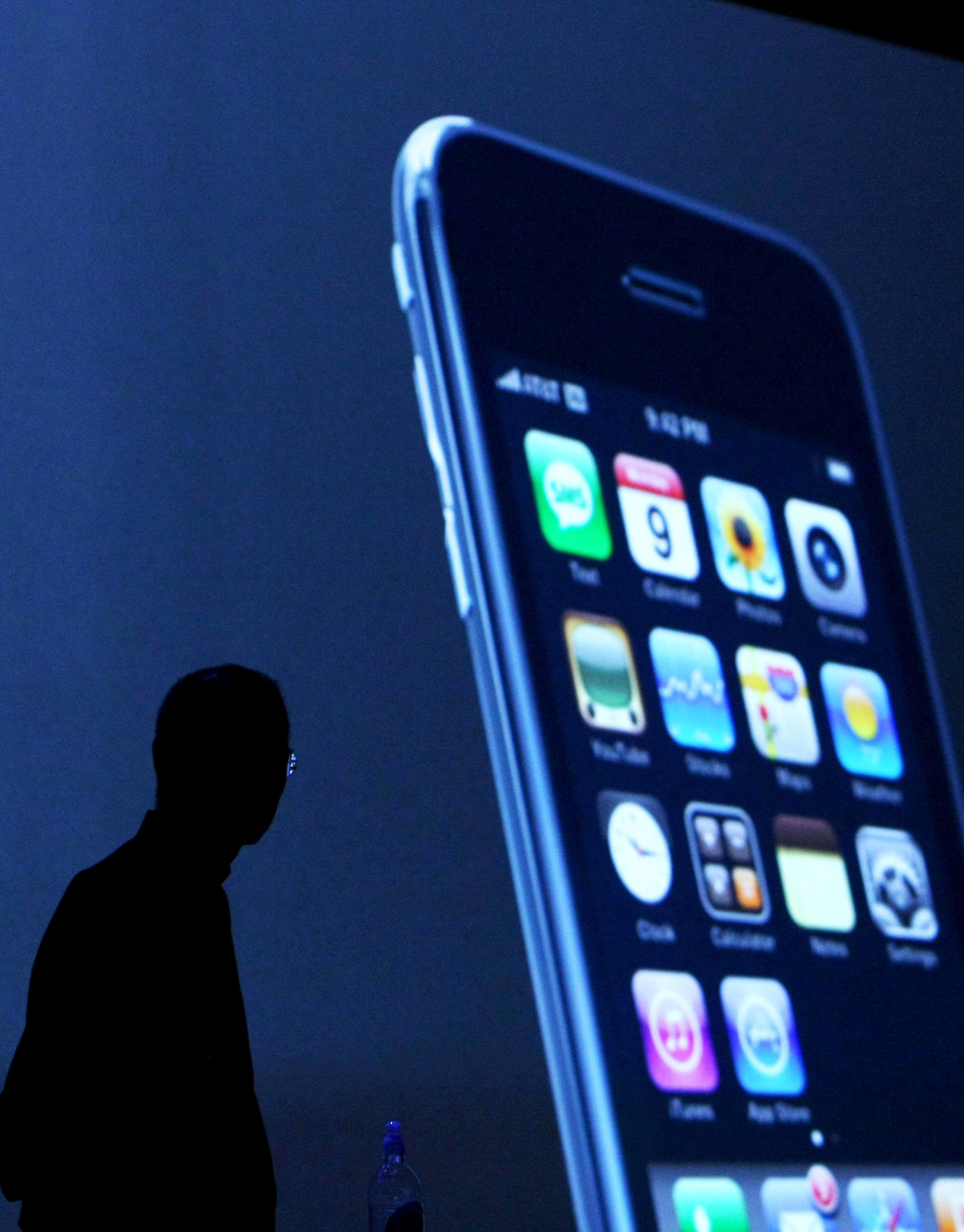 Steve Jobs stands in the shadows of the iPhone release.