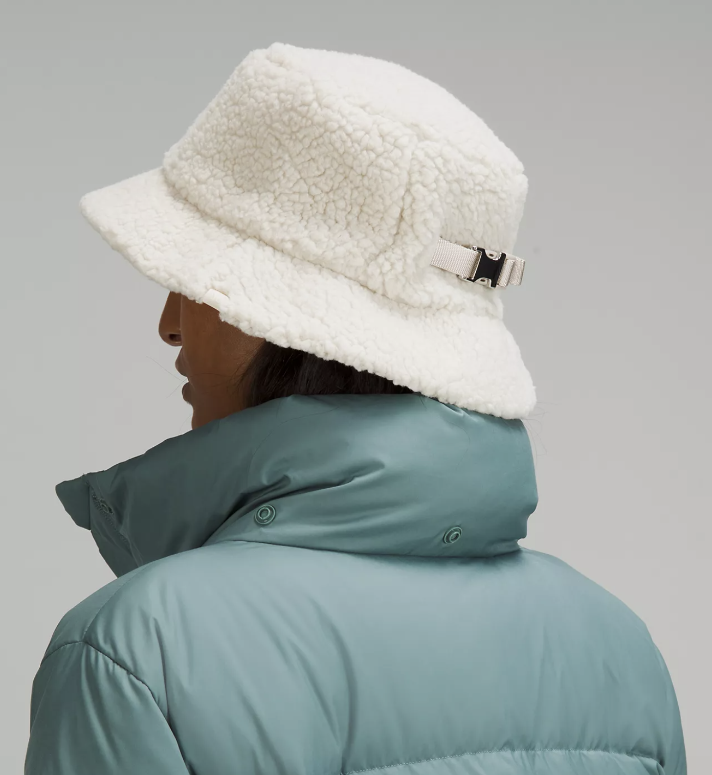 A person wearing the hat and a puffer jacket