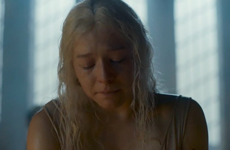 Rhaenyra looks down, emotional and exhausted