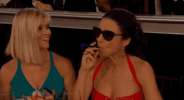 Reese Witherspoon and Julia Louis-Dreyfus vaping at an awards show