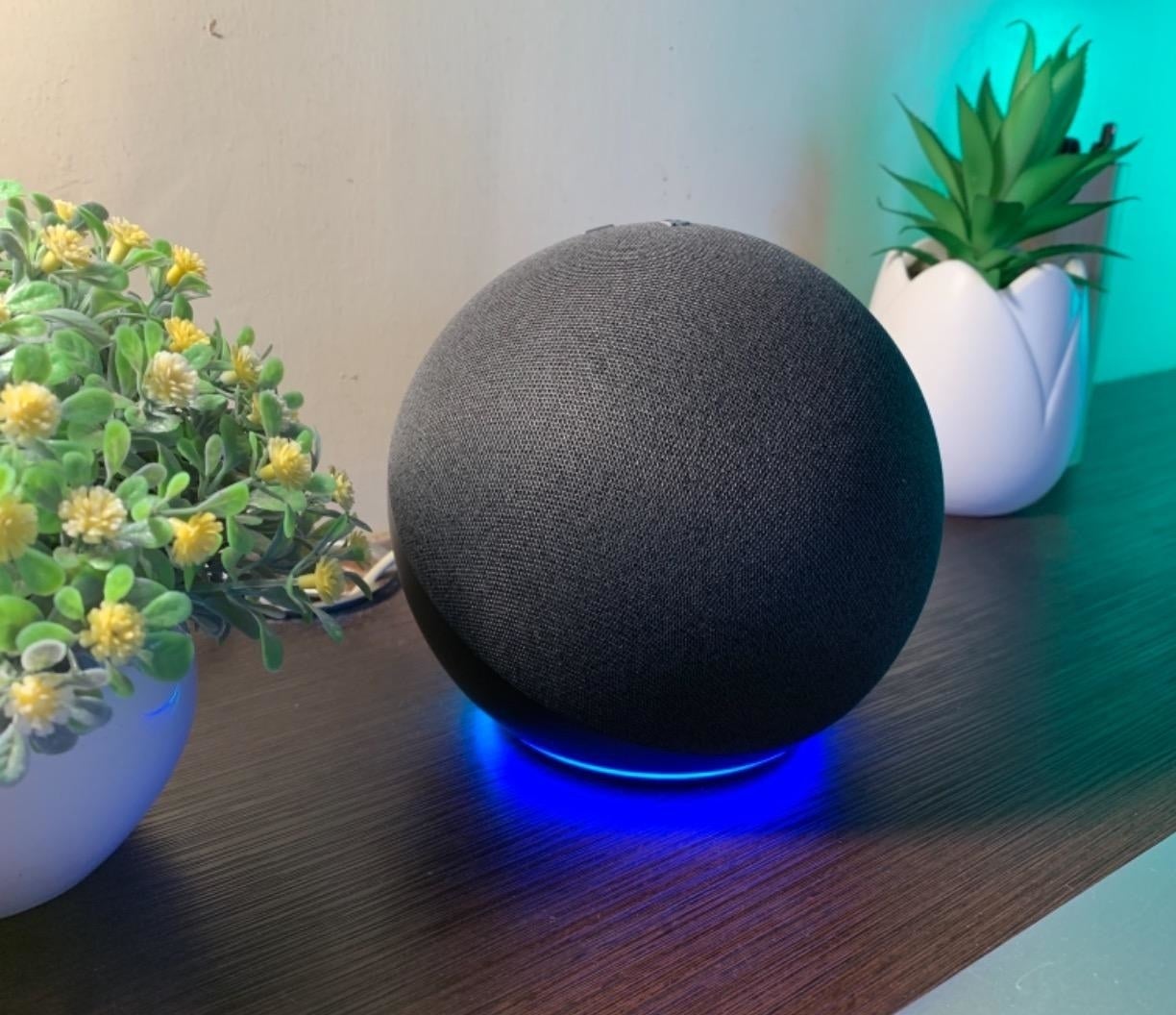 Reviewer&#x27;s black Echo sphere speaker sitting on desk with blue glow beneath