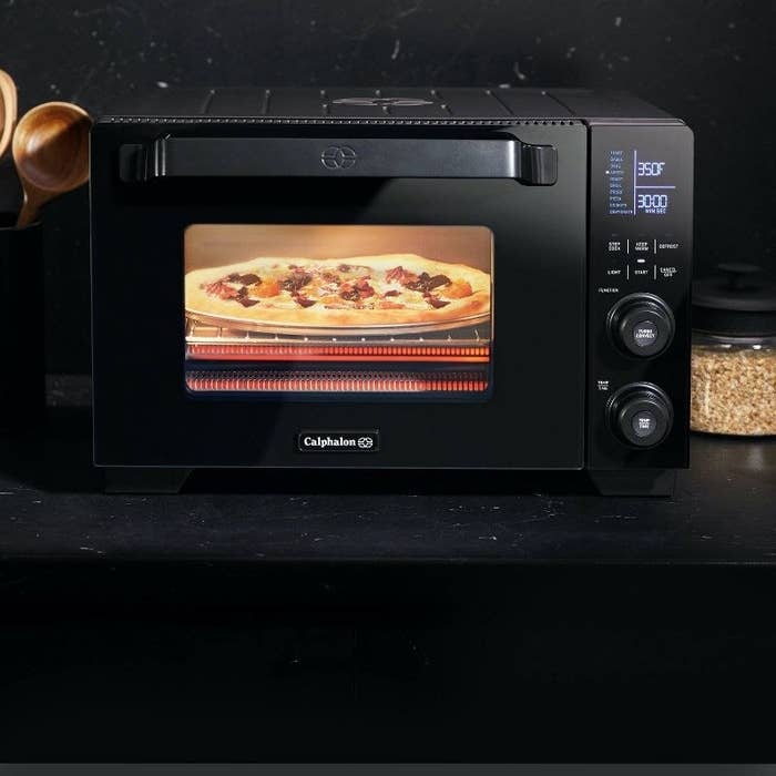 The air fryer with pizza inside