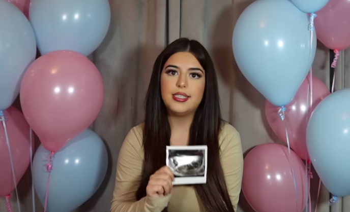 Grace holding up her ultrasound