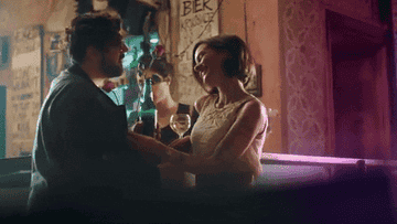 a man and a woman flirting at a bar