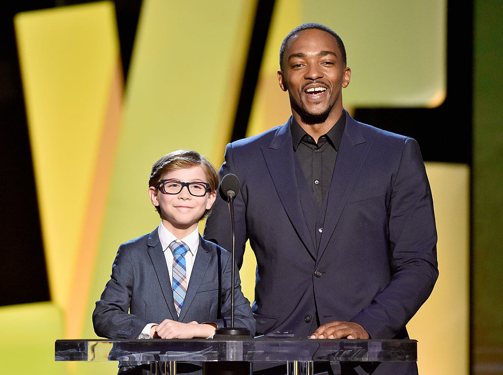 Jacob as a child presenting an award with Anthony Mackie