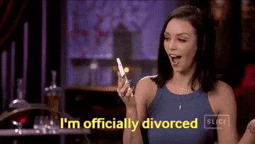 a woman looking at her phone with surprise and then smiling and saying, &quot;I&#x27;m officially divorced&quot;