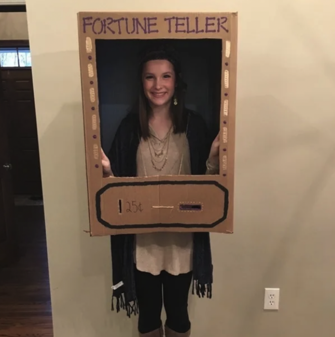 Someone with a fake fortune teller box made from cardboard over their torso