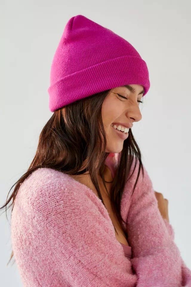 a person wearing the hat with a sweater in front of a plain background